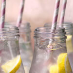 Pink lemonade in bottles with straws | photography, images, and art for hotels, office buildings, homes, restaurants, hospitals, and shopping malls