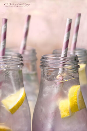 Pink lemonade in bottles with straws | photography, images, and art for hotels, office buildings, homes, restaurants, hospitals, and shopping malls